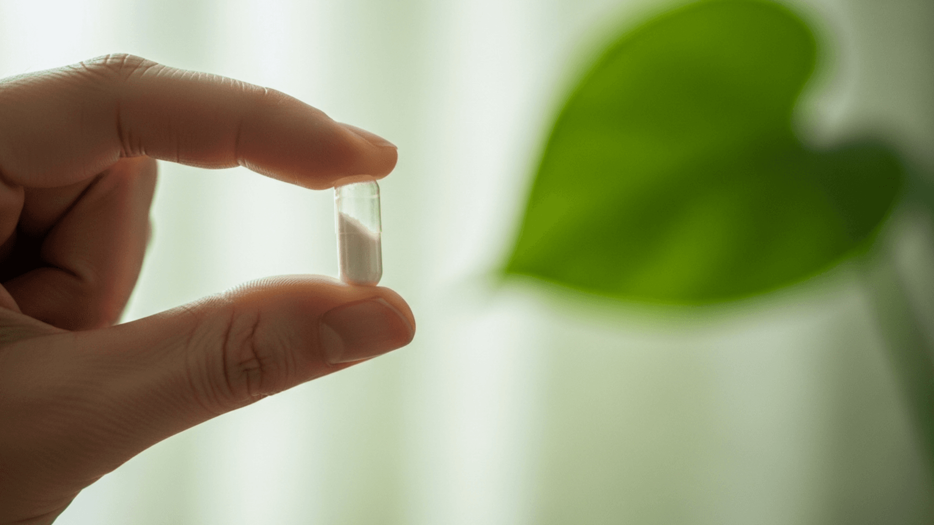 A reassuring and professional image showing a clear supplement capsule of Myo-Inositol held between two fingers, with a soft-focus, minimalist background, symbolizing safety and purity.
